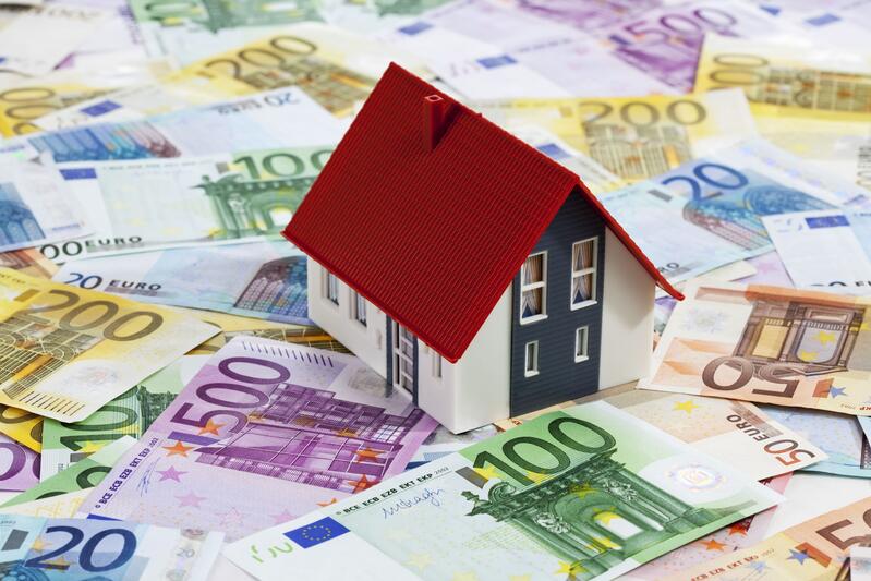 Miniatur Haus über Geldscheine